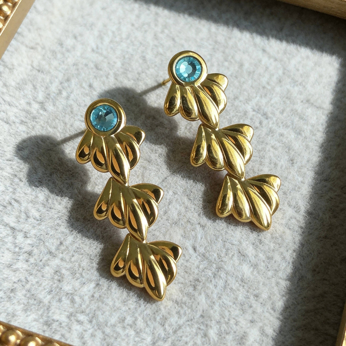 Gold Ocean Leaf Earrings with Blue Crystal